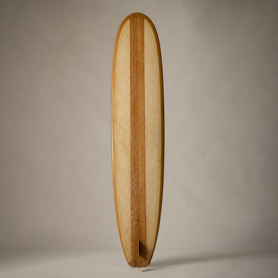 In lieu of Beau D. Bodhi: his board — a well-loved wood-grain single-fin longboard with a gold pinstripe